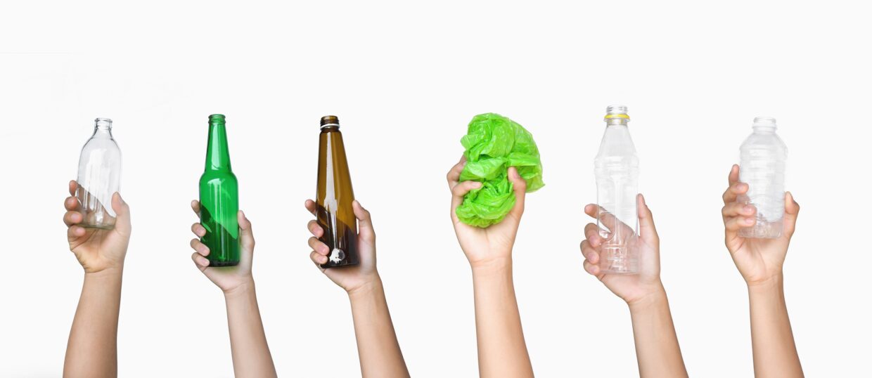 hand holding garbage of bottle glass and bottle plastic with pla